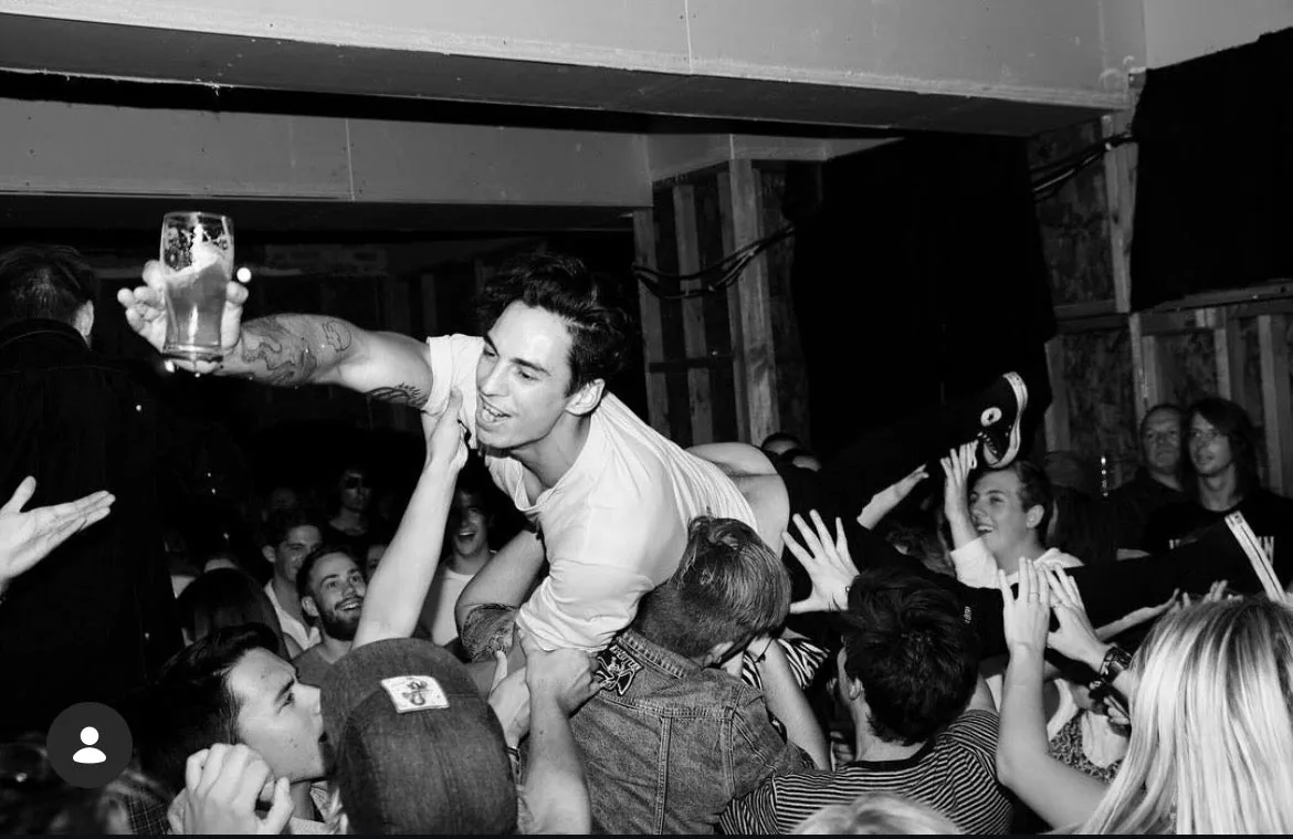Jamie crowd surfing at a show